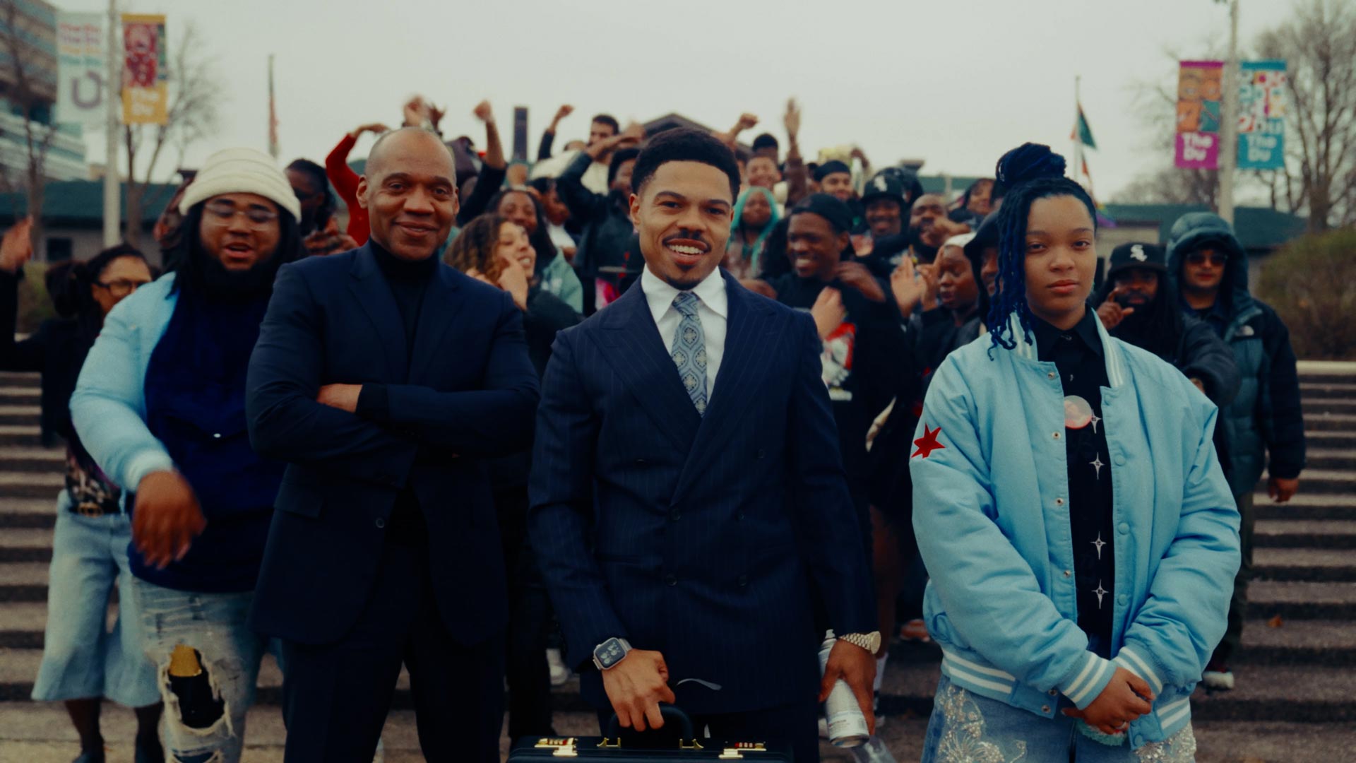Taylor Bennett in suit surrounded by family and friends